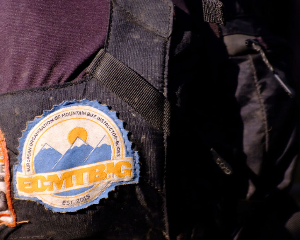 Logo in situ on a mountain bike guides pack.